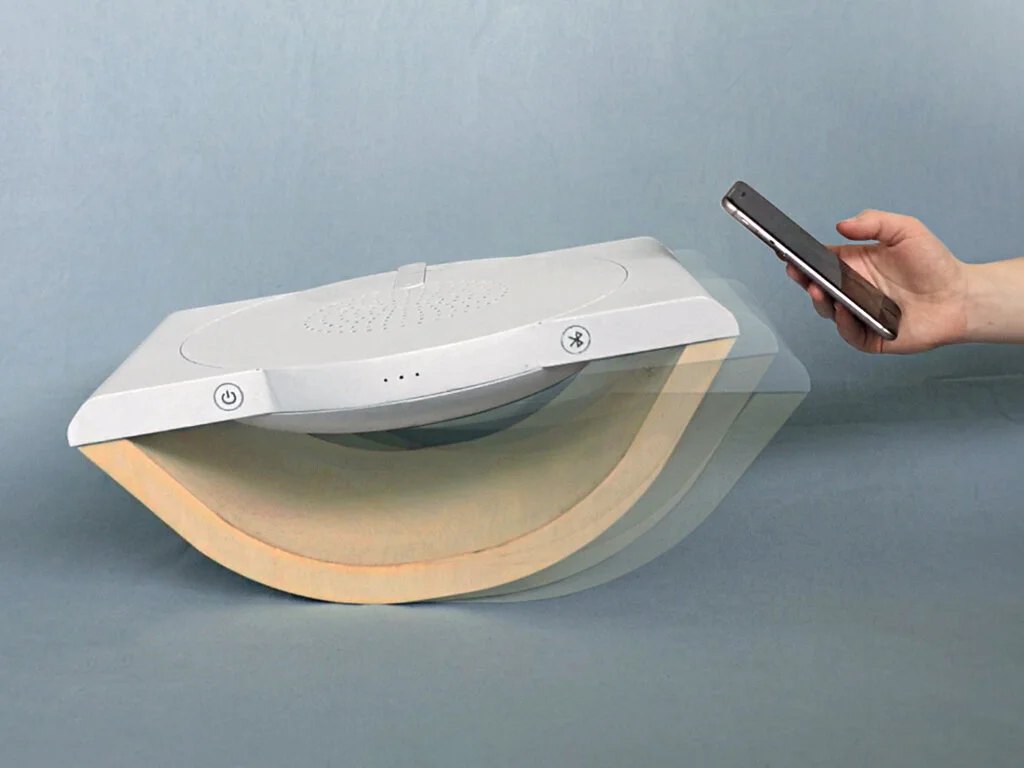 When one phone is removed, an orientation sensor detects the tilt and stops the music.