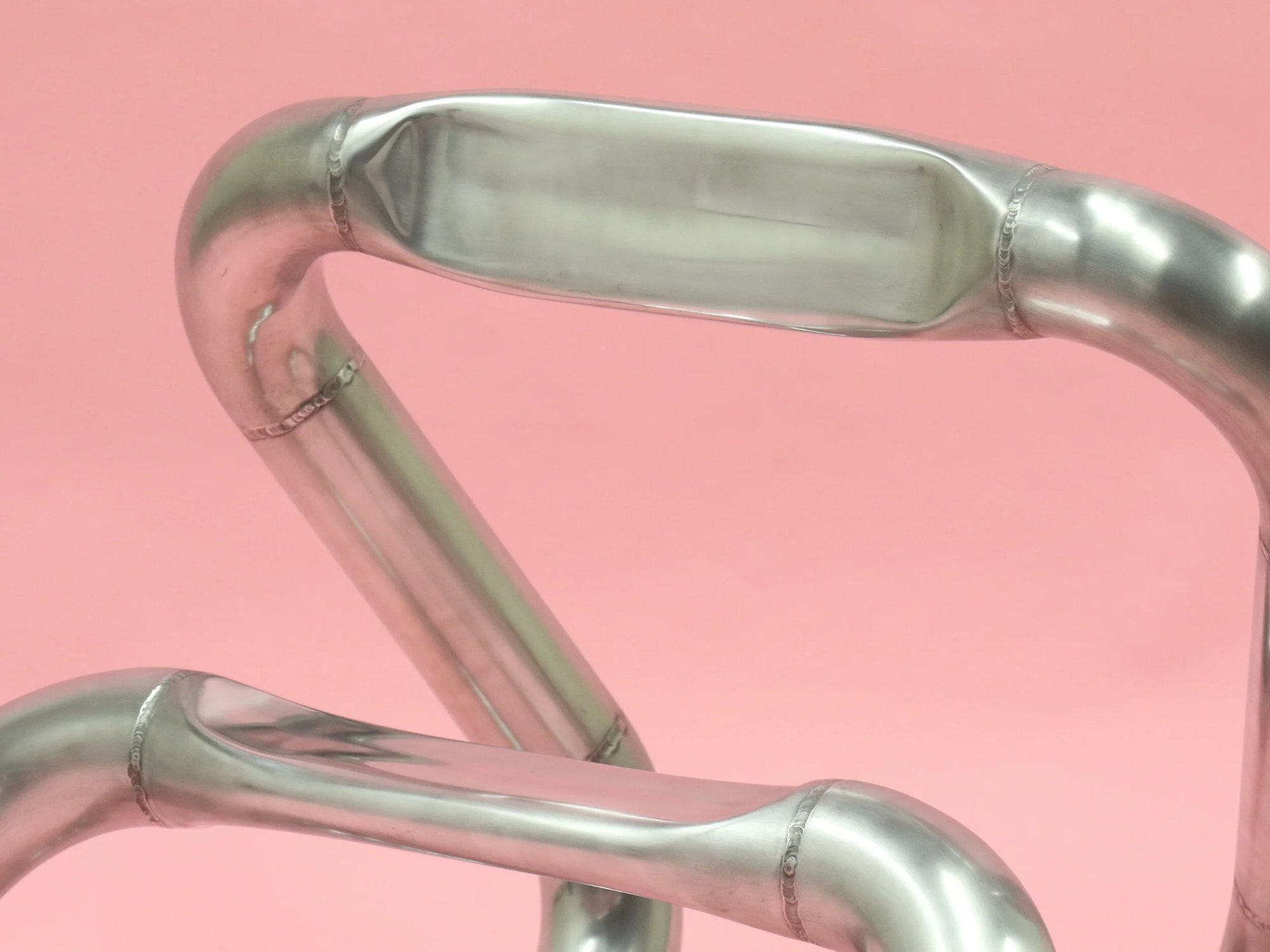 Press detail: the pressed seat and backrest sections display findings from experimenting with the limitations of metal tubing and the ability to be manipulated into a variety of forms. This also achieves larger surface area for the user when seated