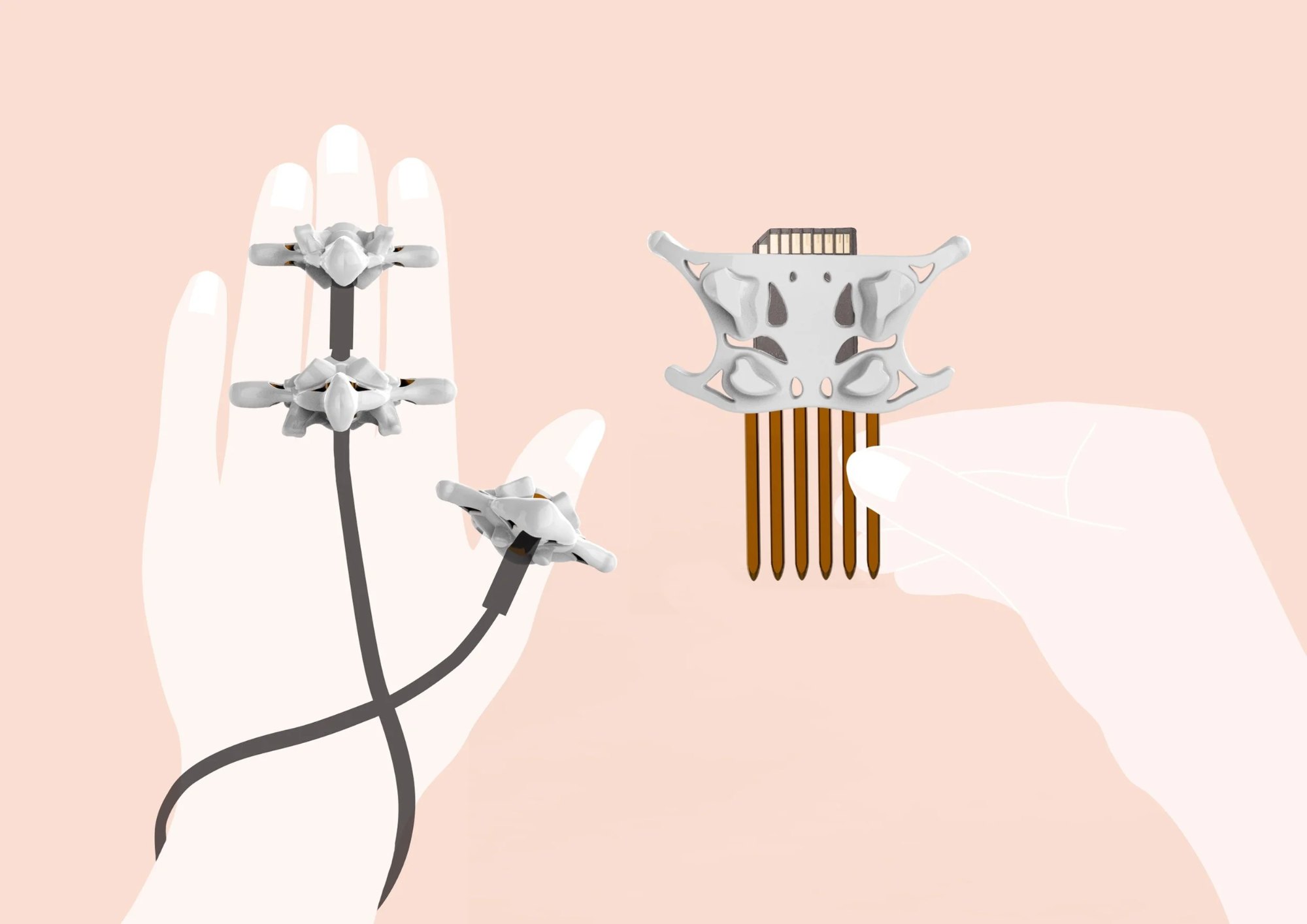 Example of how E-Os’ rings are used to intertwine USB cords around the hand. Image also shows how a standard SD card fits into the decorative comb