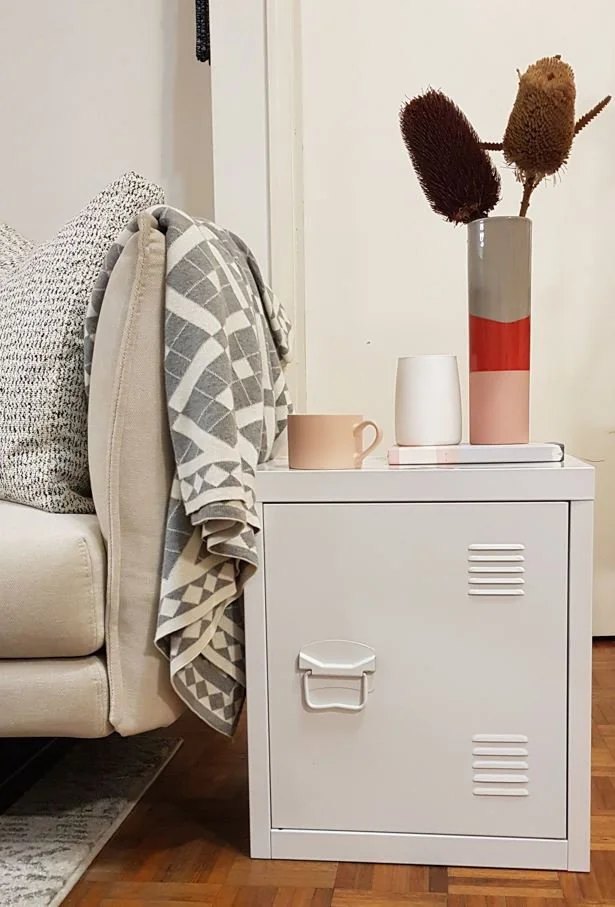 Discarded steel storage unit in re-use as a side table.