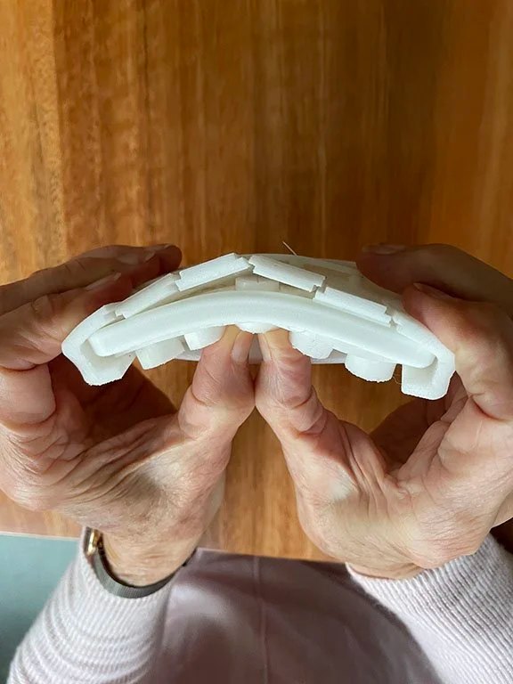 User with the 1:1 appearance model of blister pack. The user uses pressure from the base to release a pill from the modular lid system