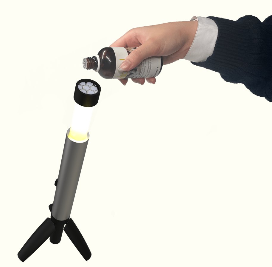Diffuser refill. This shows the terracotta diffuser which is located on the top of the light, as well as the user adding essential oil to the diffuser.