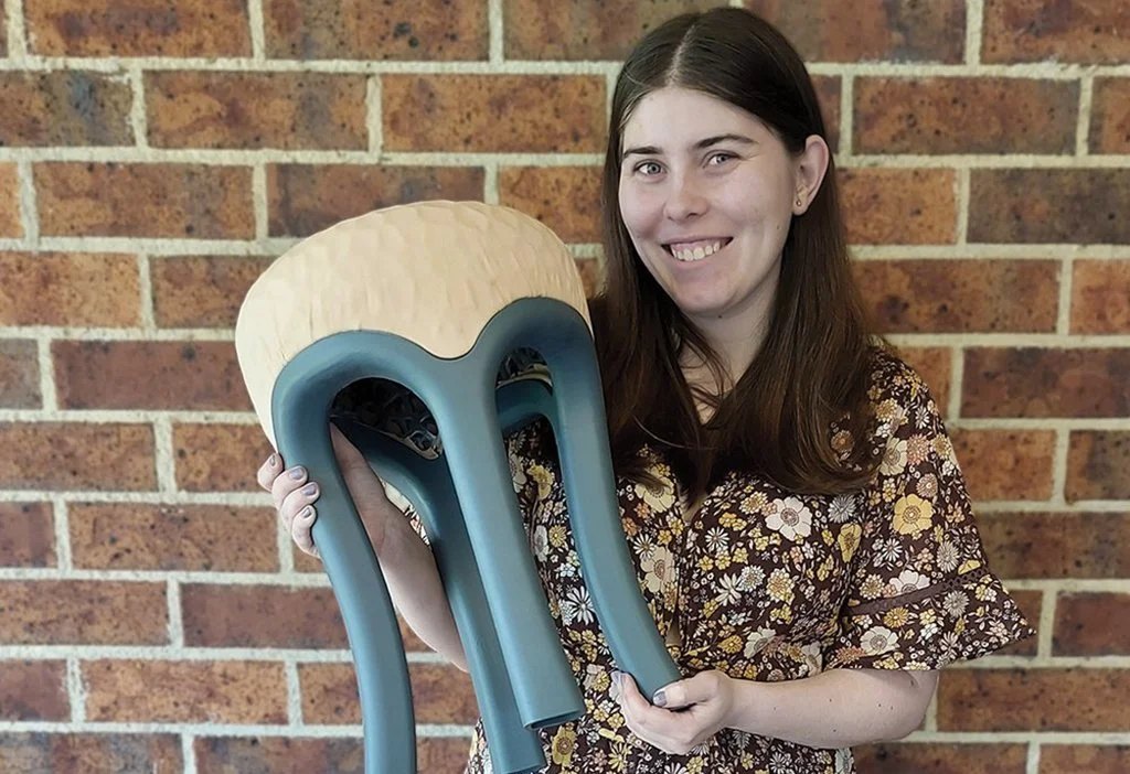 Fixture Stool being held, demonstrating its lightweight features