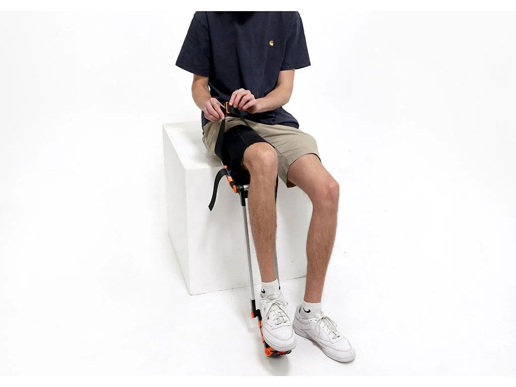 Applying the device to a user’s injured leg. A combination of adjustable neoprene and polyester straps provide environmental resilience, comfort, and a high level of versatility for a broad range of users.