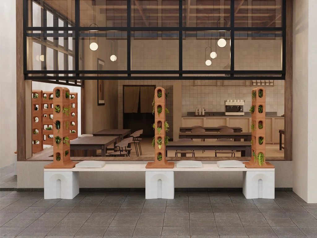 The terracotta bench system displayed in use, providing outdoor seating at an open-air café.