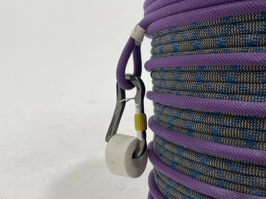 Close up of a gear loop with climbing tape attached via a carabiner.