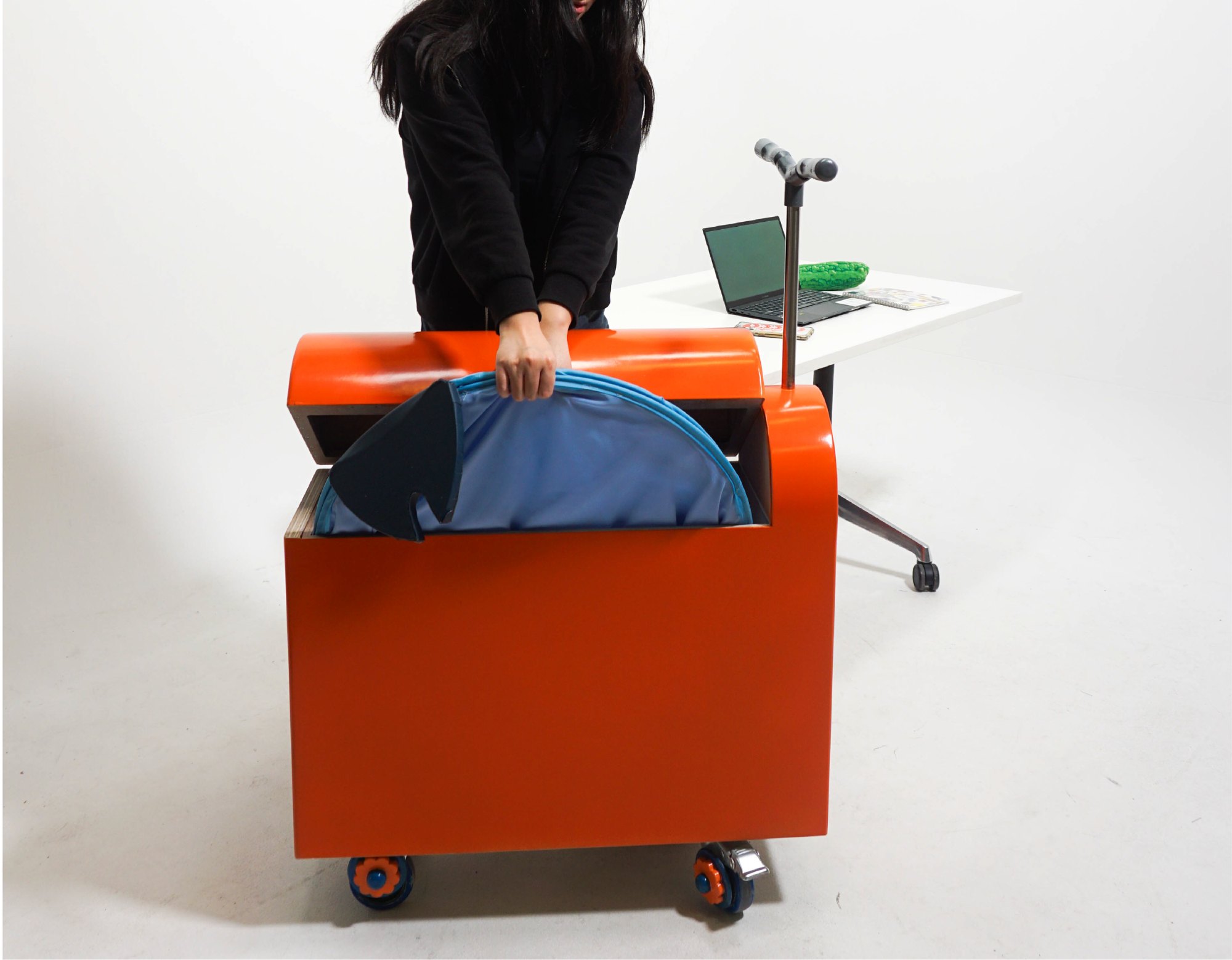 The user taking the folded pop-up hood out of the storing scooter