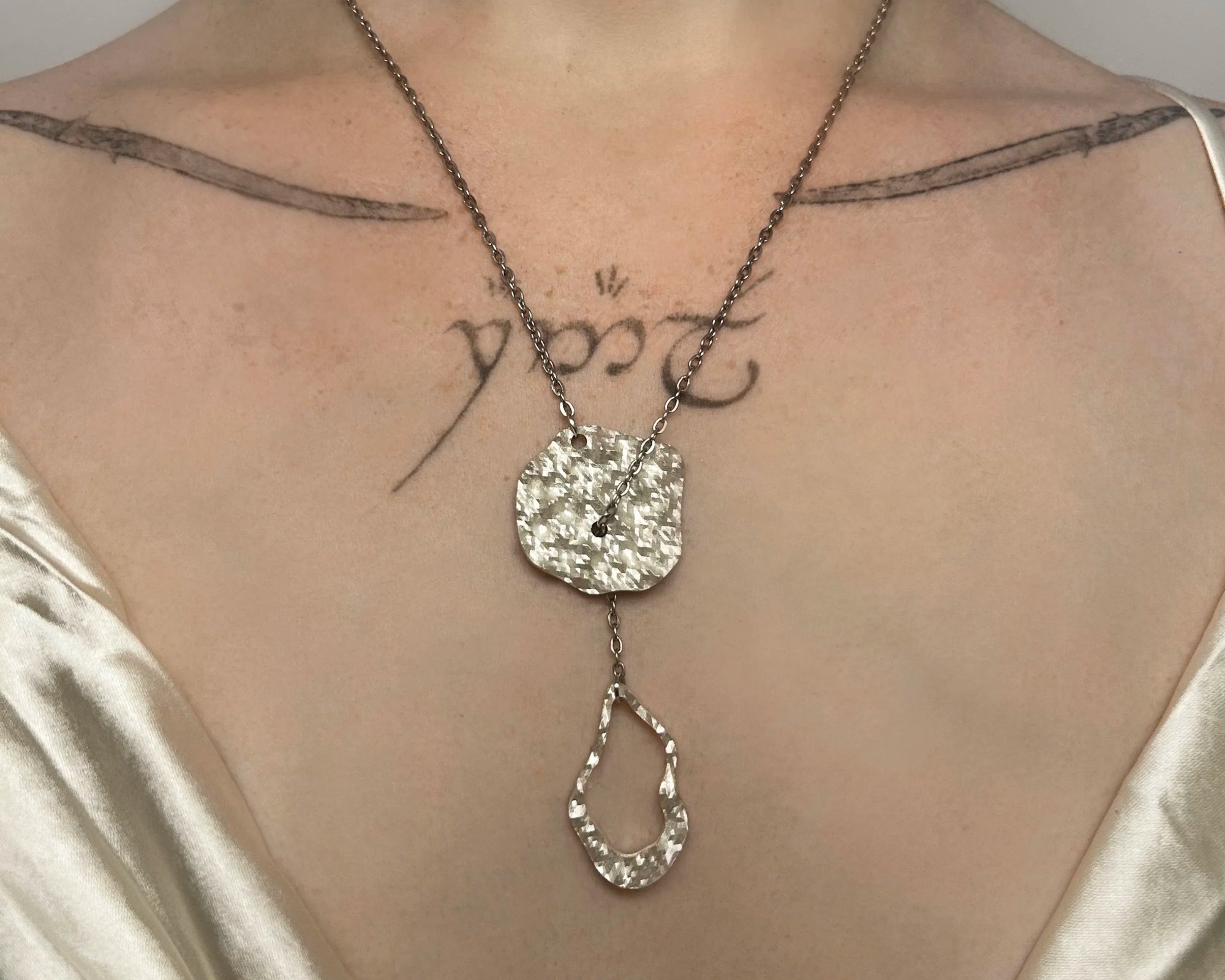 Closeup of sound-distorted slip-chain necklace